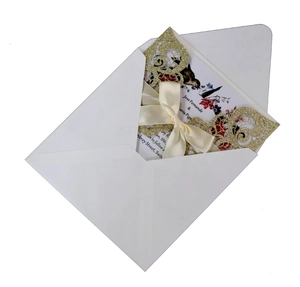 Elegant gold glitter laser-cut wedding invitation with white envelope and floral inner card