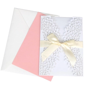 Elegant laser cut floral pink invitation set with white envelope and beige ribbon bow