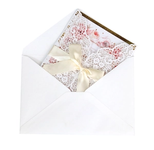 Elegant laser cut lace wedding invitation set with floral card and satin ribbon