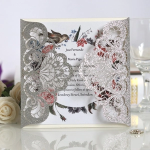 Detailed laser-cut silver glitter wedding invitation with elegant floral insert card