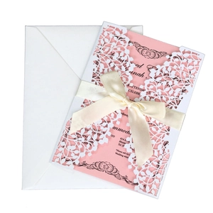 Laser cut floral wedding invitation suite with pink leaf pattern and a satin bow