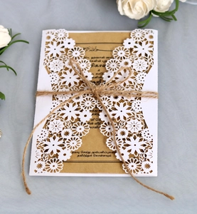 Elegant white laser cut floral wedding invitation with kraft paper insert and twine