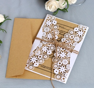 Laser cut white floral wedding invitation with kraft paper inner card and jute twine
