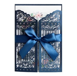 Laser cut navy blue wedding invitation with gate design and ribbon bow detail