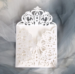 Elegant white laser-cut floral invitation pocket for weddings and celebrations on marble