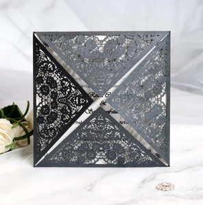 Detail of laser cut flower pattern on square grey invitation with glitter finish