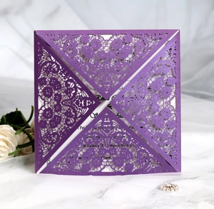 Macro view of purple laser cut floral lace invitation with pearlescent finish and white insert