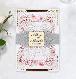 Elegant laser-cut floral wedding invitation with silver glitter belt and flower inner card