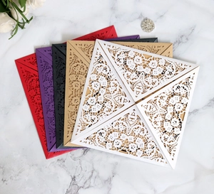 Detailed laser-cut floral and butterfly patterns on colorful cardstock invitations