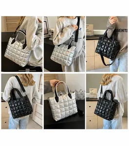 Quilted down fabric tote bag showing metallic finish detail and adjustable strap
