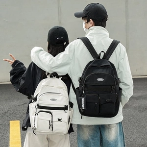 Minimalist black and white school backpacks with multi-pocket design and fashion pendant