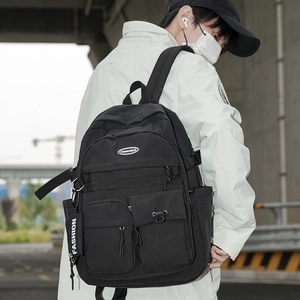Minimalist black cargo backpack with high-capacity pockets for outdoor school and travel