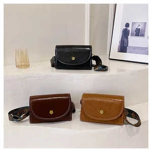 Detailed close-up of retro crossbody bags with golden flower buckles and jacquard straps
