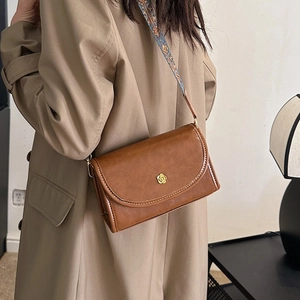 Vintage brown crossbody bag with flower buckle and patterned strap for women