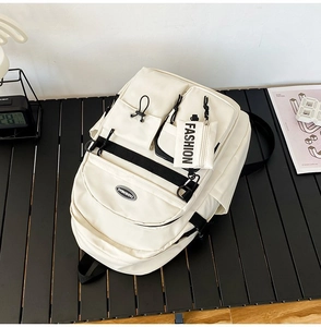 Detail of off-white cargo backpack showing durable nylon fabric and fashion tag