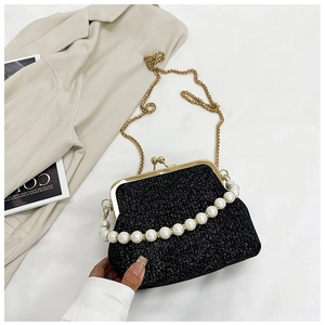 Close-up of glitter fabric evening bag with faux pearl handle and gold clasp