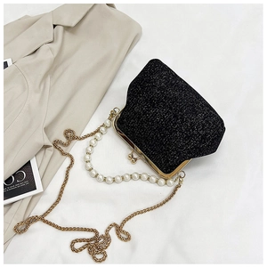 Detail of black sequin evening bag featuring pearl handle and gold chain strap