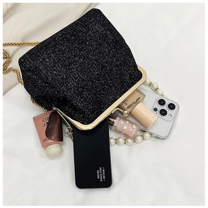 Detail view of black sequin evening bag showing interior capacity for phone and cosmetics