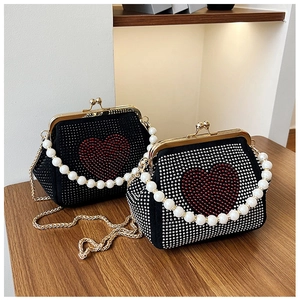 Detailed macro view of retro heart pattern rhinestones on black evening clutch bags