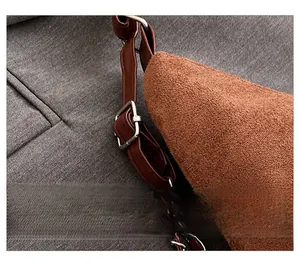 Detail of brown faux suede strap featuring silver square adjustment buckle and metal chain
