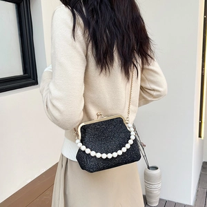 Elegant black glitter handbag with pearl handle and golden chain, retro clasp style