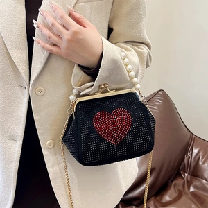 Elegant black evening clutch with red rhinestone heart, pearl handle, and gold chain strap