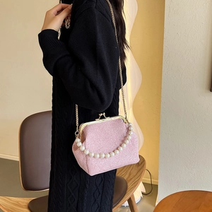 Pink sequin evening bag with metal clasp and pearl handle for elegant occasions