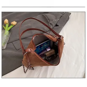 Spacious interior of a vintage brown matte tote bag holding a tablet and daily items