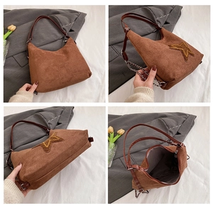 Detailed views of vintage brown suede tote bag with large star patch and chain strap