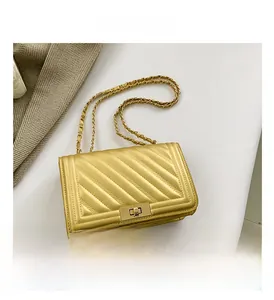 Detailed macro view of the gold quilted leather texture and metallic turn-lock closure