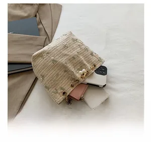 Interior view of beige woven bucket bag showing storage space for phone and wallet