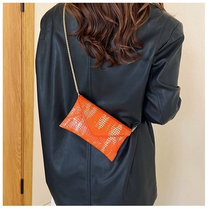 Fashionable bright orange snake texture envelope bag with gold chain strap for women