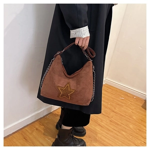 Detail of dark brown frosted suede Hobo bag with plush star patch and chain
