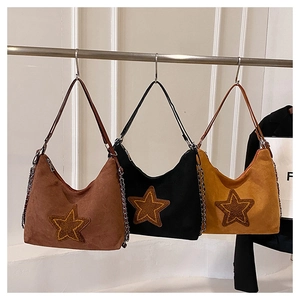 Three vintage matte hobo bags in brown, black, and yellow with star patch and chain