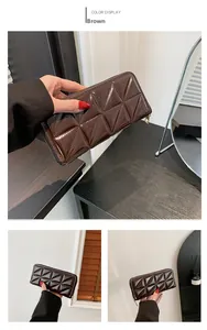 Détail du sac à main matelassé en cuir verni marron avec fermeture éclair dorée chic