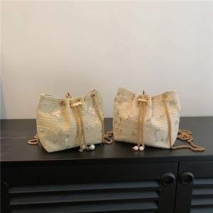 Fashionable woven straw bucket bag with floral embroidery, gold chains and pearl accents