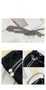 Detail of drawstring bucket bag with floral jacquard fabric and pearl chain strap