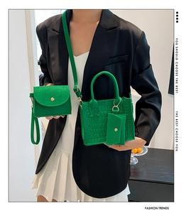 Vibrant green felt tote bag set shown on model featuring three matching pieces for style