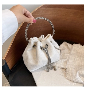 Detail of white drawstring bucket bag with rose floral texture and pearl chain handle