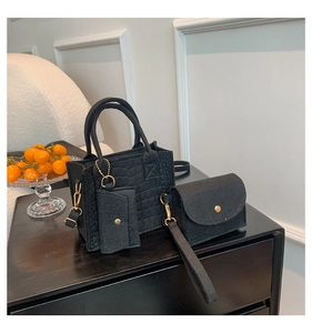 Three-piece black felt bag set including tote and mini pouch with golden hardware details