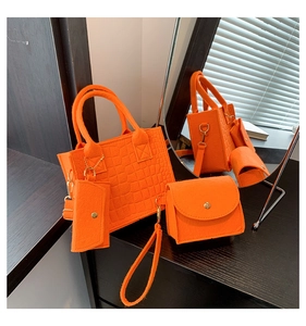Detailed view of an orange felt handbag 3-piece set with embossed crocodile texture