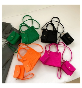 Close-up of crocodile pattern mini tote bag set with detachable wristlet and coin purse