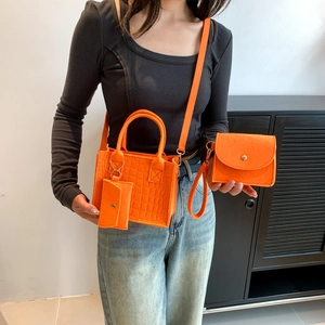Three-piece orange felt handbag set with tote and shoulder straps worn by a model
