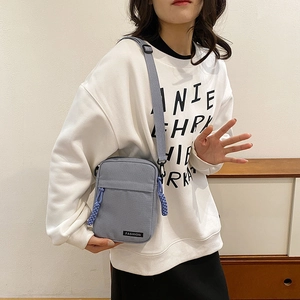Minimalist light blue canvas crossbody bag with adjustable strap for casual daily use