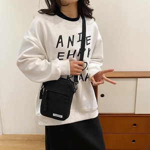 Minimalist black canvas crossbody bag with Fashion label and adjustable strap