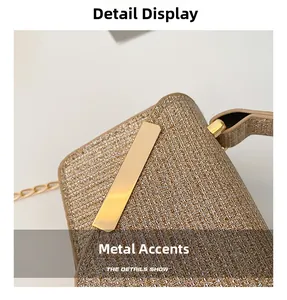 Detail showing the golden glitter textured fabric and mirror metal hardware on the bag