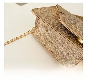 Close-up of champagne gold sequined mini bag showing fine stitching and metal chain detail