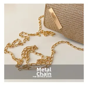 Detail shot of the shimmering gold glitter texture and elegant metal chain strap of the bag