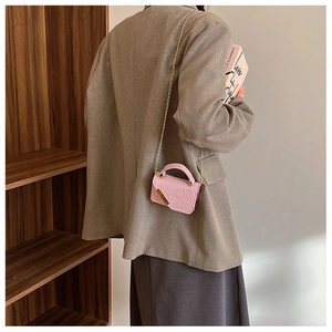 Chic pink glitter mini crossbody bag for women with gold chain strap shown on model