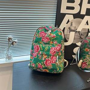 Detailed view of large capacity canvas backpack featuring traditional red peony floral pattern